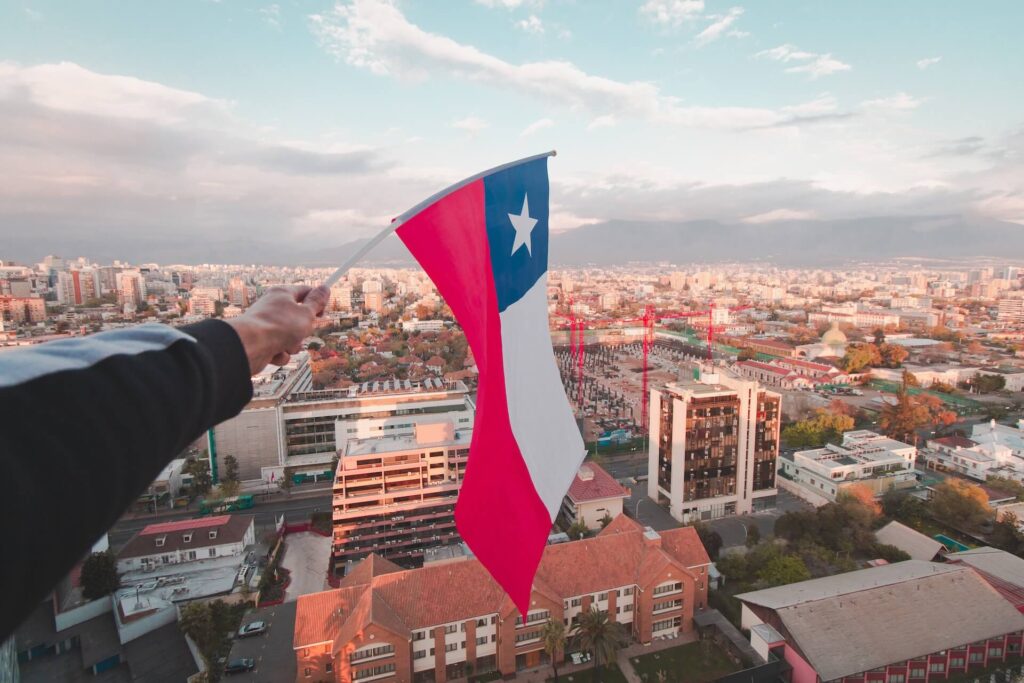 chilean flag against a backdrop of santiago