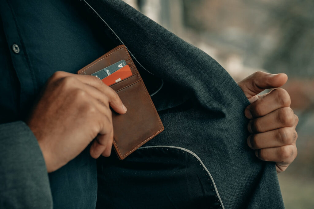 man reaching to his wallet to pay for something