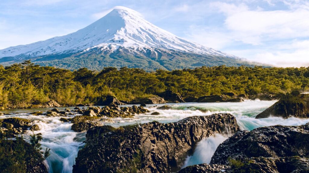 beautiful volcano in front of waterfall in chile national park