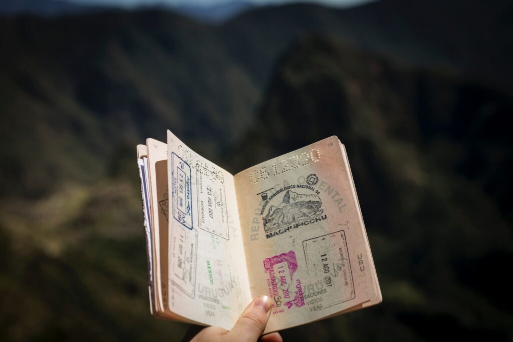 open passport in front of machu picchu
