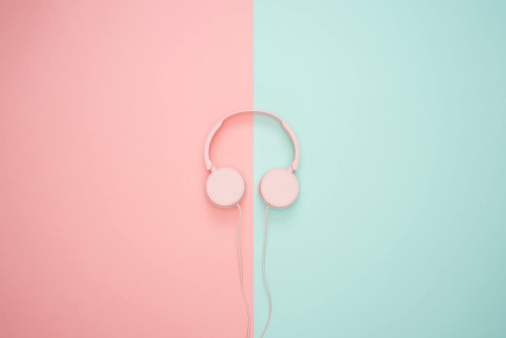 headphones against a pink and turquoise background