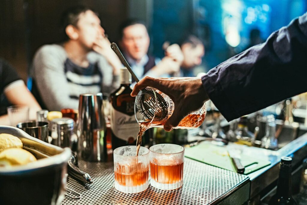 bartender serving two cocktails